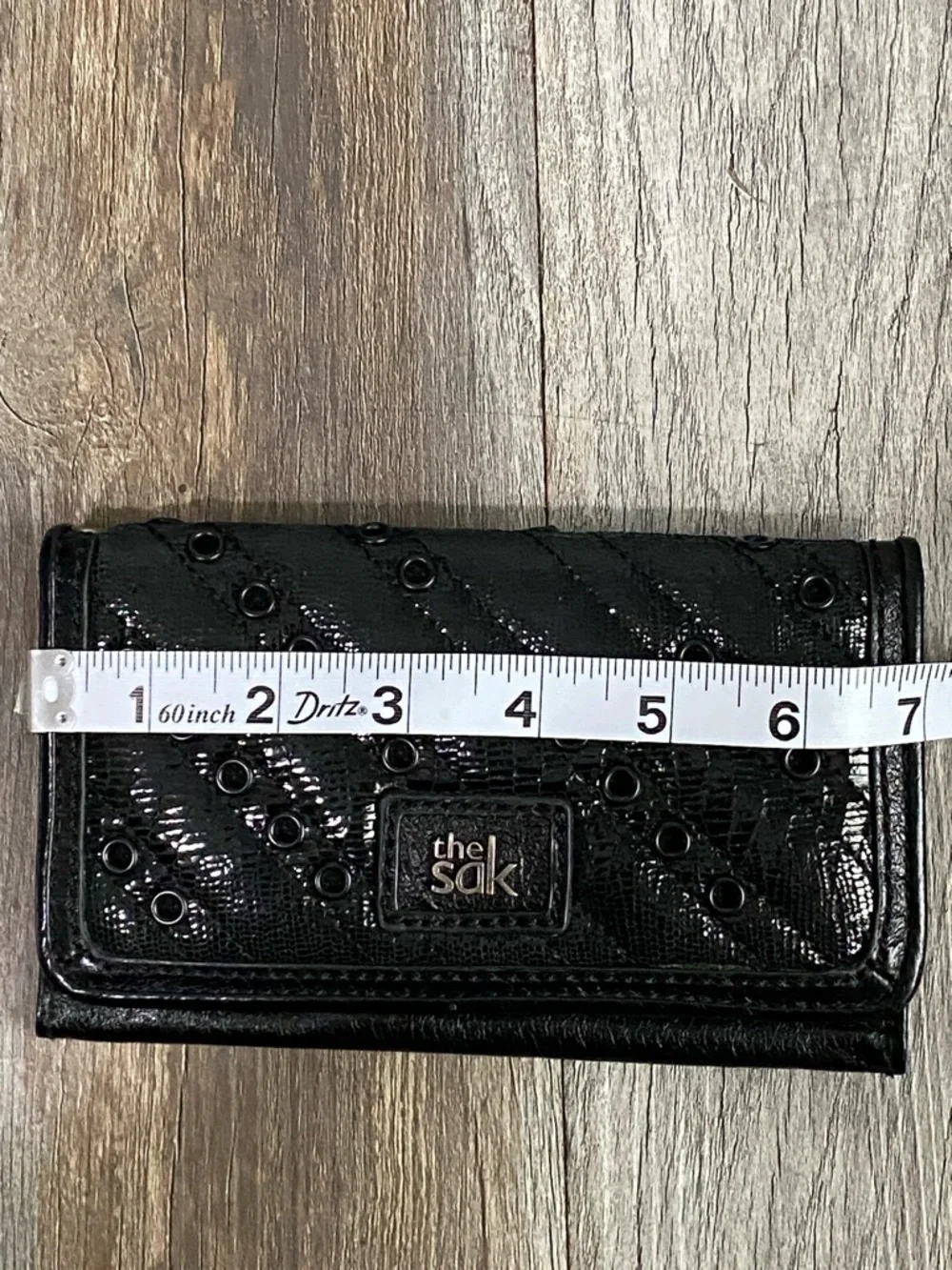 The Sak Black Quilted Eyelet Trifold Leather Wallet with Logo Plaque